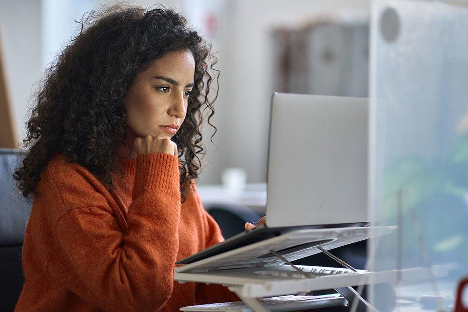 Woman researching options on her laptop